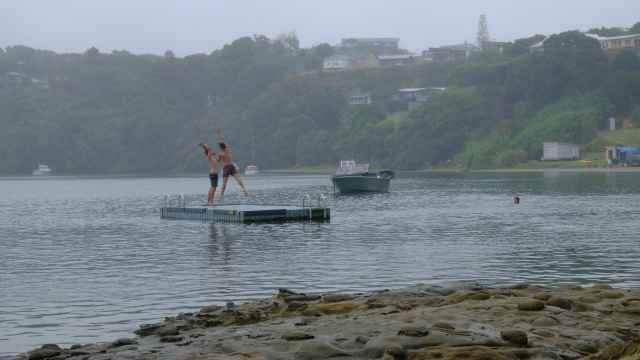 Men on pontoon about to dive into sea